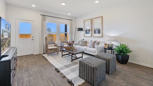 Large living area with large windows for natural lighting.