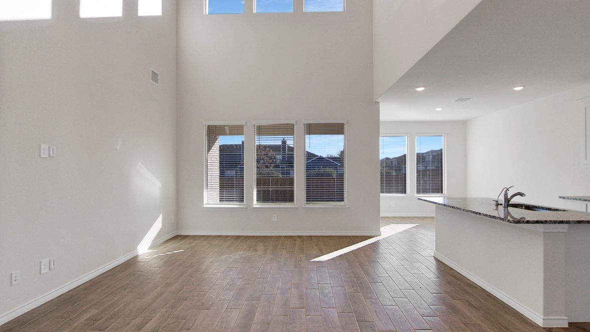 Spacious open-concept first floor living room with large windows
