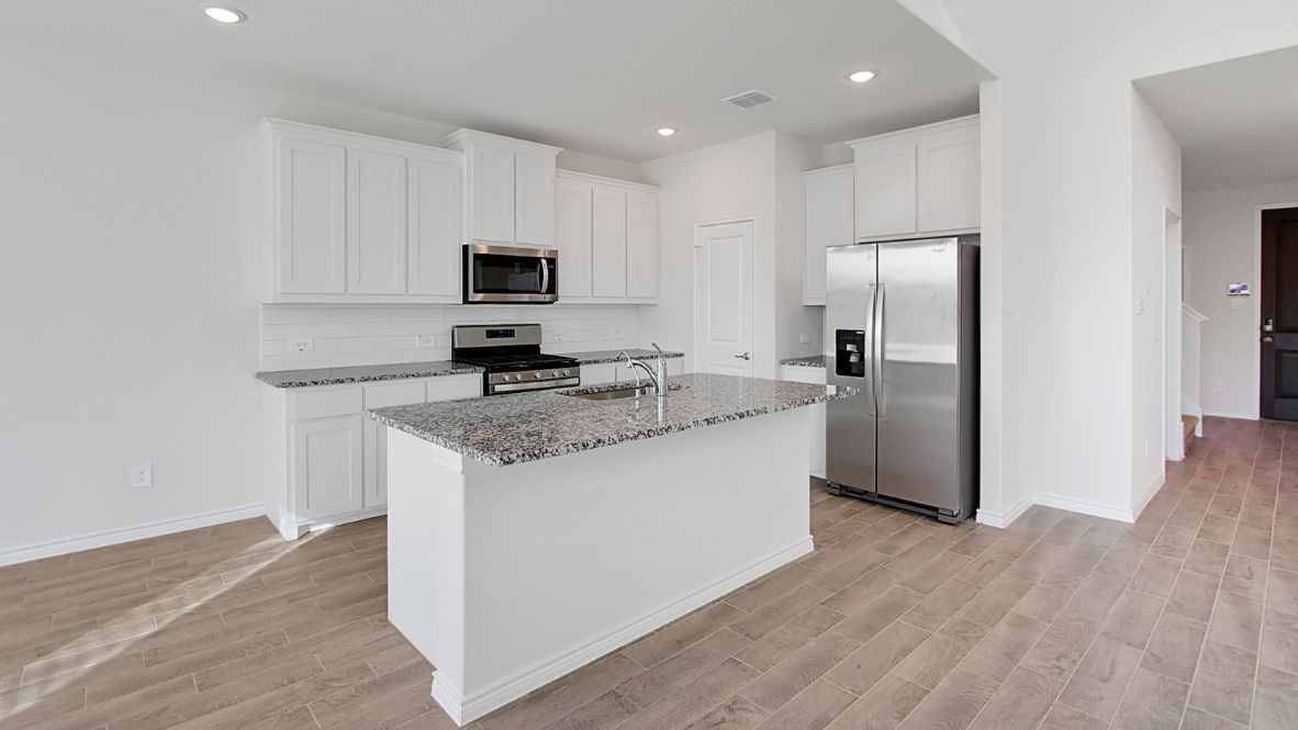 Spacious kitchen with granite countertops and central island