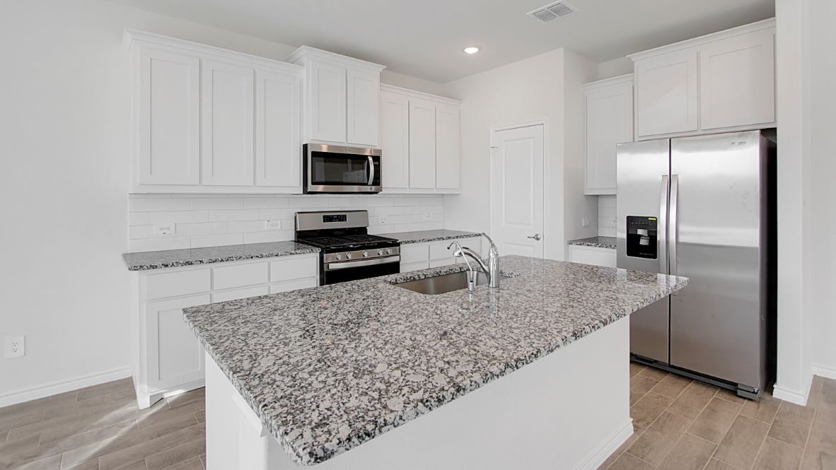 Spacious kitchen with granite countertops and central island