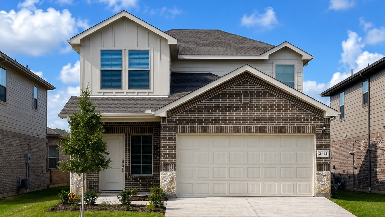 Exterior two-story brick house in Arlington, Texas. Jasmine floor plan.