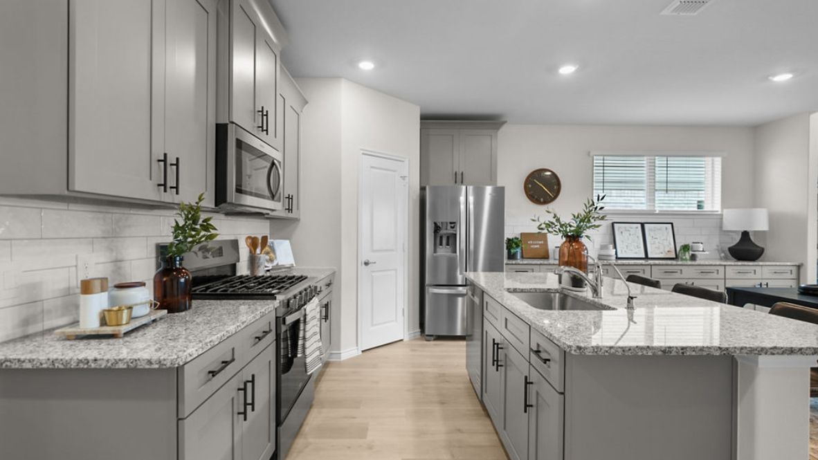 Interior kitchen with center island and light grey cabinets