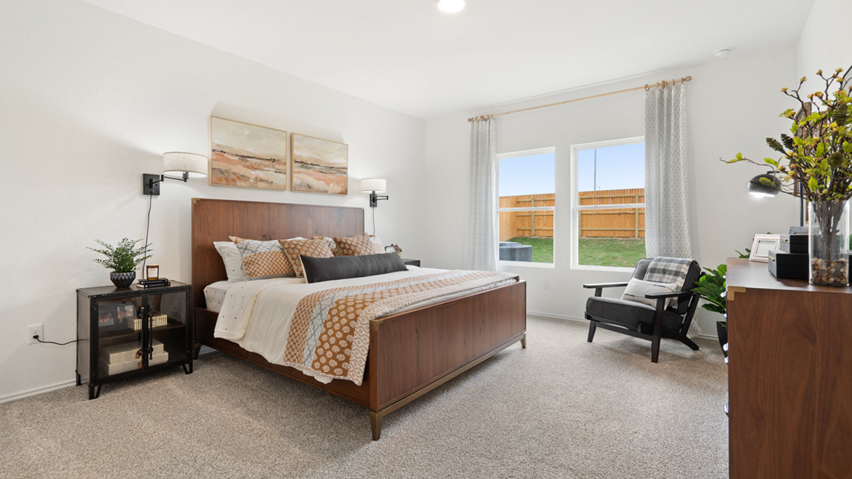 The primary bedroom ensuite is tucked away off the family room. Enjoy a peaceful start to your day in this space with the luxurious walk-in shower, double vanity, private toilet area with a door, and a large walk-in closet.