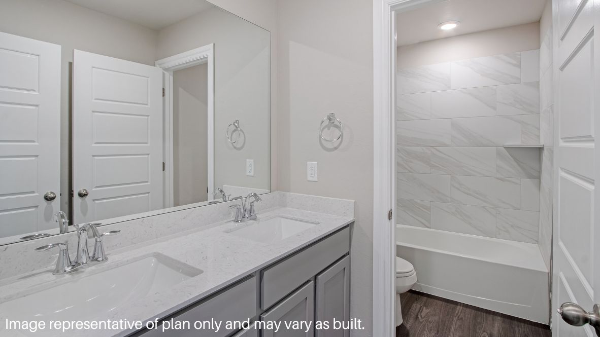 Resuming through the upstairs hallway, you will see the three secondary bedrooms and the secondary bathroom. Each of the three secondary bedrooms has carpeted flooring, a tall closet, and a large window. The secondary bathroom has vinyl floors, a double sink, and a tub/shower combo.
