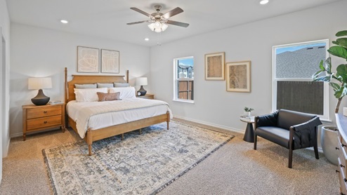 bedroom with beige carpet, white walls and a window