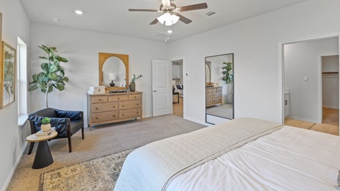 bedroom with beige carpet, white walls and a window