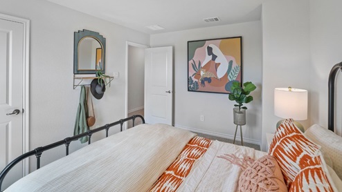 bedroom with beige carpet, grey walls and a window