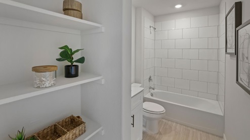 bathroom with a vanity sink, toilet and shower
