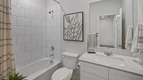 bathroom with a vanity sink, toilet and shower