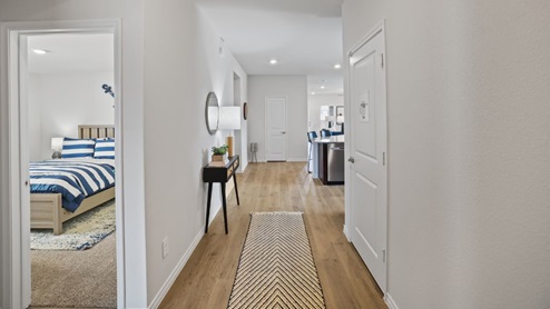 front entry way of home featuring brown flooring and white walls