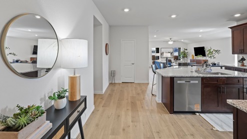 front entry way of home featuring brown flooring and white walls