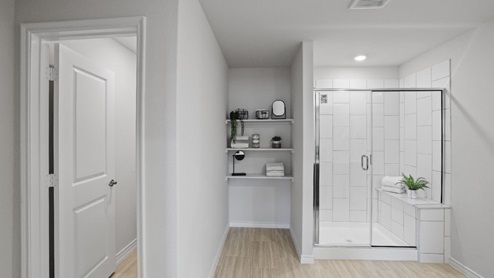 bathroom with dual vanity sinks, toilet, and a walk in shower