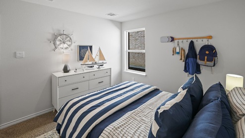 bedroom with beige carpet, white walls and a window