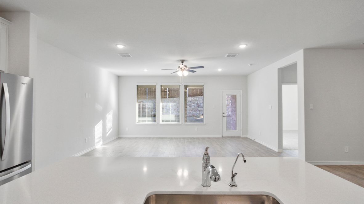 Contemporary kitchen adorned with white cabinets seamlessly integrated into an open dining area layout.
