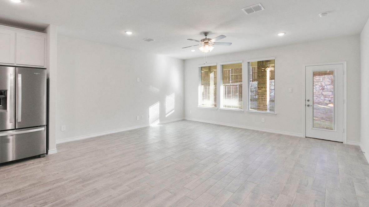 Living area unfurnished with windows