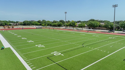 Wide shot of JJ Pearce High School campus in Richardson, TX, showing athletic fields