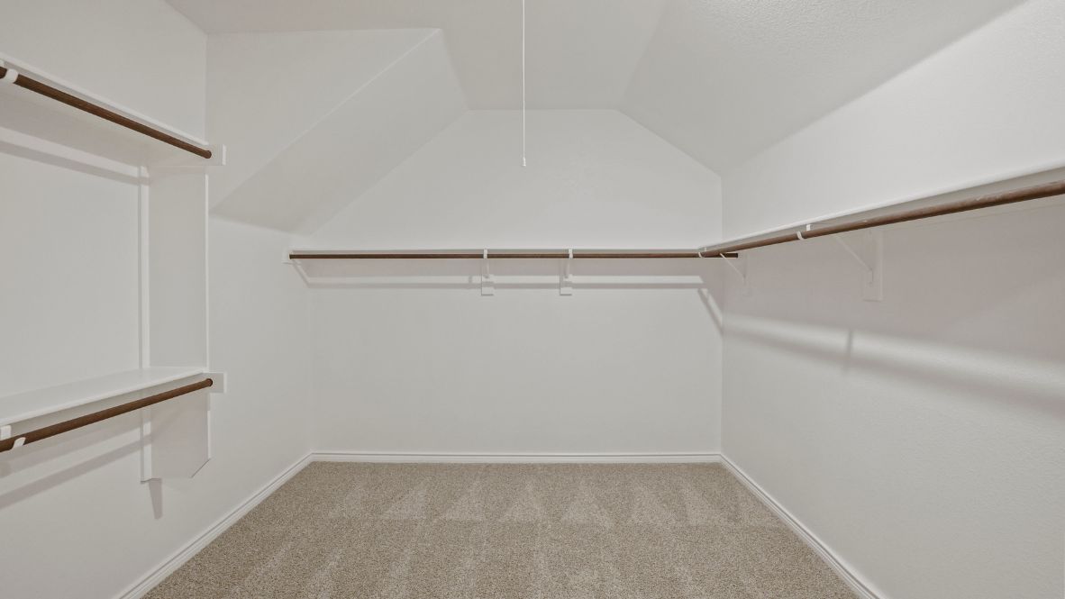 Welcome to the Ozark, the perfect family home where comfort, style, and fun meet! This spacious two-story home offers 2,577 sq. ft. of living space, including 4 bedrooms and 3 bathrooms, designed with family living in mind. As you approach the home, you'll be greeted by a charming elongated front porch that leads into a welcoming foyer. Just off the foyer, you'll find a cozy secondary bedroom and bath, perfect for guests or as a private home office, plus a convenient tiled utility room.  The heart of the home is the open, bright kitchen that flows seamlessly into the family living area. Imagine cooking in your gorgeous kitchen, complete with spacious quartz countertops, classic white 4x16 subway tile backsplash, stainless steel appliances, and a large kitchen island with a deep, single-bowl sink. The walk-in corner pantry provides plenty of space to store your essentials. The adjoining dining area is perfect for family meals and entertaining friends.  Retreat to the main bedroom located privately at the back of the home. It features a luxurious ensuite with double vanity sinks, a huge walk-in closet, and a large walk-in shower with glossy white 10x14 subway tile surround.  Upstairs, you'll find a family-friendly movie room, ideal for cozy nights with the kids, holiday movie marathons, or simply enjoying quality time together. The game room leads to two more guest bedrooms and a third full bathroom.  Enjoy outdoor family gatherings with a covered rear patio (per plan) and a professionally landscaped yard. The Ozark also comes with smart home technology through our HOME IS CONNECTED base package, so you can control the lights, thermostat, and locks right from your phone.  Ready to find your dream family home? Call today to schedule a tour of the Ozark and see how it’s designed for family fun and comfort!