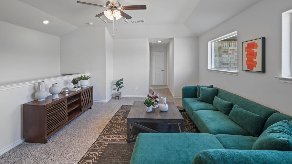 Welcome to the Ozark, the perfect family home where comfort, style, and fun meet! This spacious two-story home offers 2,577 sq. ft. of living space, including 4 bedrooms and 3 bathrooms, designed with family living in mind. As you approach the home, you'll be greeted by a charming elongated front porch that leads into a welcoming foyer. Just off the foyer, you'll find a cozy secondary bedroom and bath, perfect for guests or as a private home office, plus a convenient tiled utility room.  The heart of the home is the open, bright kitchen that flows seamlessly into the family living area. Imagine cooking in your gorgeous kitchen, complete with spacious quartz countertops, classic white 4x16 subway tile backsplash, stainless steel appliances, and a large kitchen island with a deep, single-bowl sink. The walk-in corner pantry provides plenty of space to store your essentials. The adjoining dining area is perfect for family meals and entertaining friends.  Retreat to the main bedroom located privately at the back of the home. It features a luxurious ensuite with double vanity sinks, a huge walk-in closet, and a large walk-in shower with glossy white 10x14 subway tile surround.  Upstairs, you'll find a family-friendly movie room, ideal for cozy nights with the kids, holiday movie marathons, or simply enjoying quality time together. The game room leads to two more guest bedrooms and a third full bathroom.  Enjoy outdoor family gatherings with a covered rear patio (per plan) and a professionally landscaped yard. The Ozark also comes with smart home technology through our HOME IS CONNECTED base package, so you can control the lights, thermostat, and locks right from your phone.  Ready to find your dream family home? Call today to schedule a tour of the Ozark and see how it’s designed for family fun and comfort!