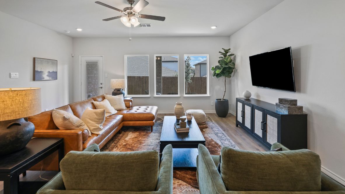 Welcome to the Ozark, the perfect family home where comfort, style, and fun meet! This spacious two-story home offers 2,577 sq. ft. of living space, including 4 bedrooms and 3 bathrooms, designed with family living in mind. As you approach the home, you'll be greeted by a charming elongated front porch that leads into a welcoming foyer. Just off the foyer, you'll find a cozy secondary bedroom and bath, perfect for guests or as a private home office, plus a convenient tiled utility room.  The heart of the home is the open, bright kitchen that flows seamlessly into the family living area. Imagine cooking in your gorgeous kitchen, complete with spacious quartz countertops, classic white 4x16 subway tile backsplash, stainless steel appliances, and a large kitchen island with a deep, single-bowl sink. The walk-in corner pantry provides plenty of space to store your essentials. The adjoining dining area is perfect for family meals and entertaining friends.  Retreat to the main bedroom located privately at the back of the home. It features a luxurious ensuite with double vanity sinks, a huge walk-in closet, and a large walk-in shower with glossy white 10x14 subway tile surround.  Upstairs, you'll find a family-friendly movie room, ideal for cozy nights with the kids, holiday movie marathons, or simply enjoying quality time together. The game room leads to two more guest bedrooms and a third full bathroom.  Enjoy outdoor family gatherings with a covered rear patio (per plan) and a professionally landscaped yard. The Ozark also comes with smart home technology through our HOME IS CONNECTED base package, so you can control the lights, thermostat, and locks right from your phone.  Ready to find your dream family home? Call today to schedule a tour of the Ozark and see how it’s designed for family fun and comfort!