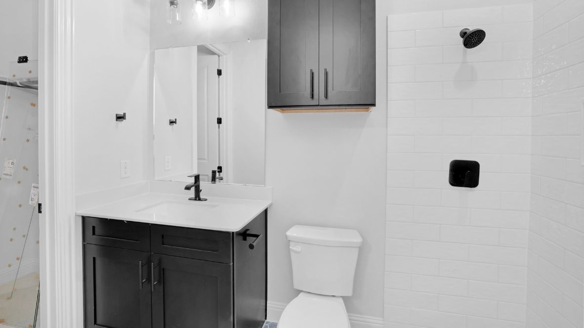 Bathroom with a sink, toilet, and shower.