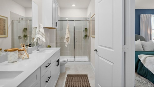 Interior primary bathroom with double sink and shower