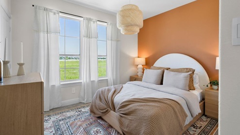 Interior bedroom with accent wall and large window