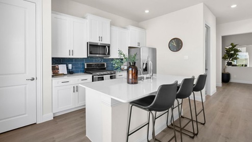Interior kitchen with center island with white cabinets