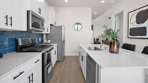 Interior kitchen with center island with white cabinets