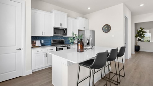 Interior kitchen with center island with white cabinets