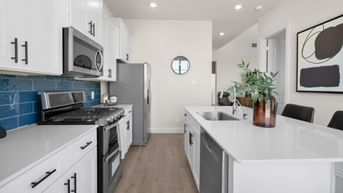 Interior kitchen with center island with white cabinets