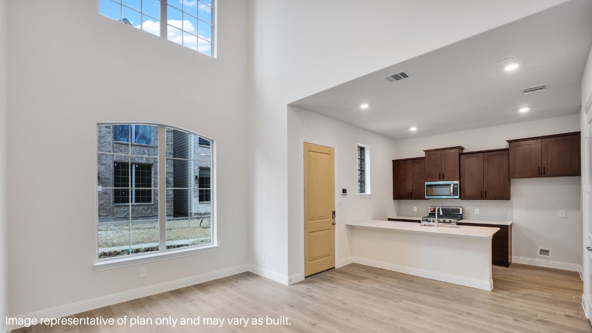 Step inside and be greeted by an open-concept living space, where natural light pours through large windows, enhancing the sleek picture-frame cabinetry, stainless steel appliances, and quartz or granite countertops in the chef-inspired kitchen.