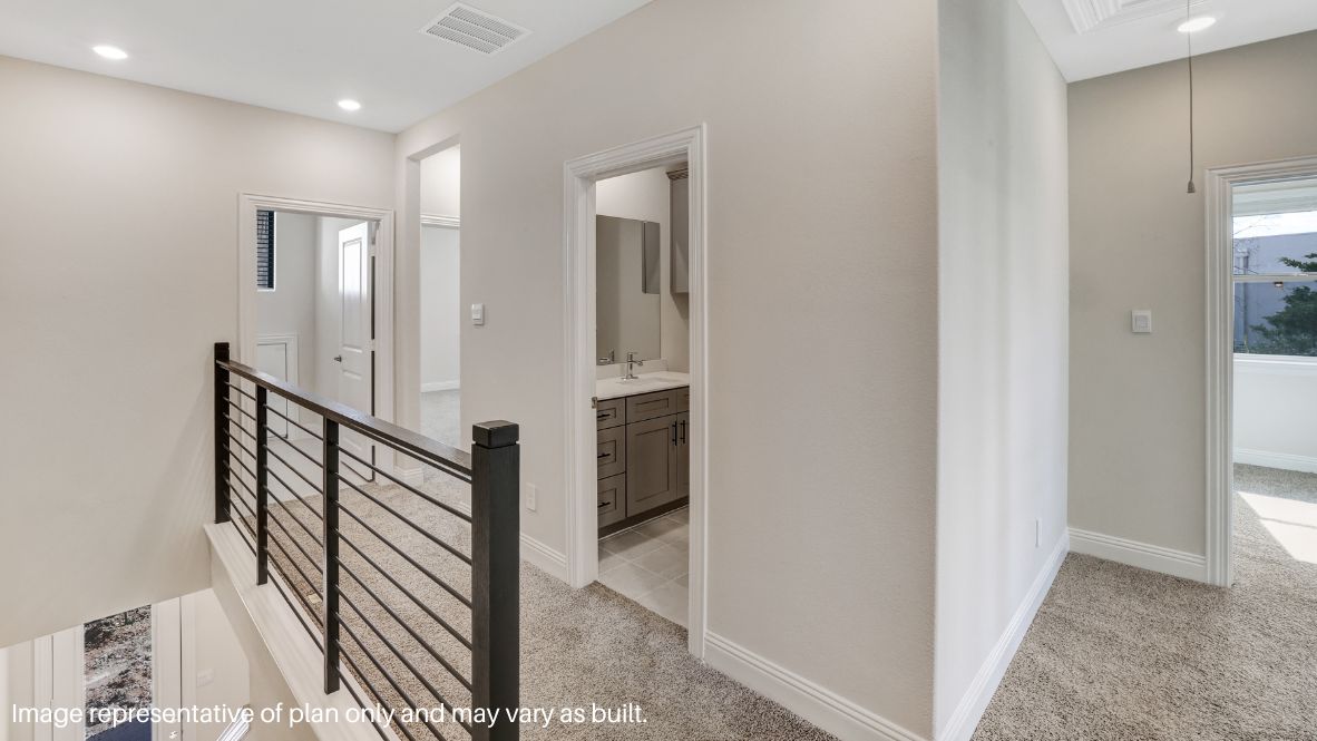 while the second level features a spacious primary suite with a walk-in closet, dual vanity bath, and two additional bedrooms.