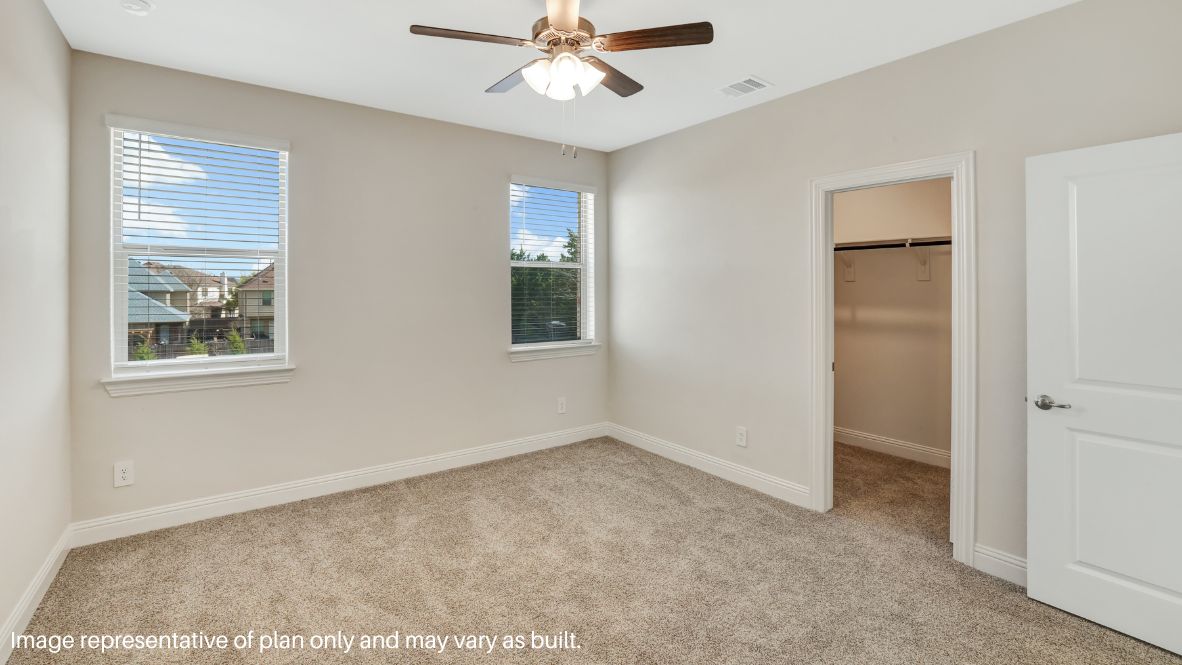 while the second level features a spacious primary suite with a walk-in closet, dual vanity bath, and two additional bedrooms.