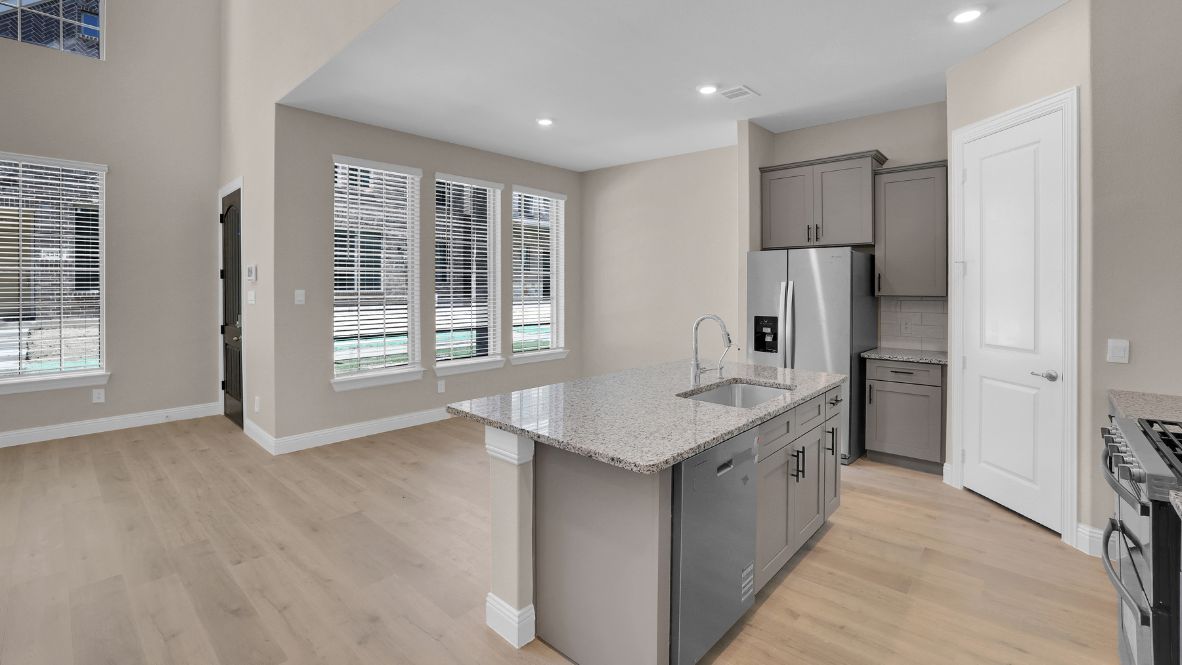 Open-concept dining area facing windows providing plenty of natural light.