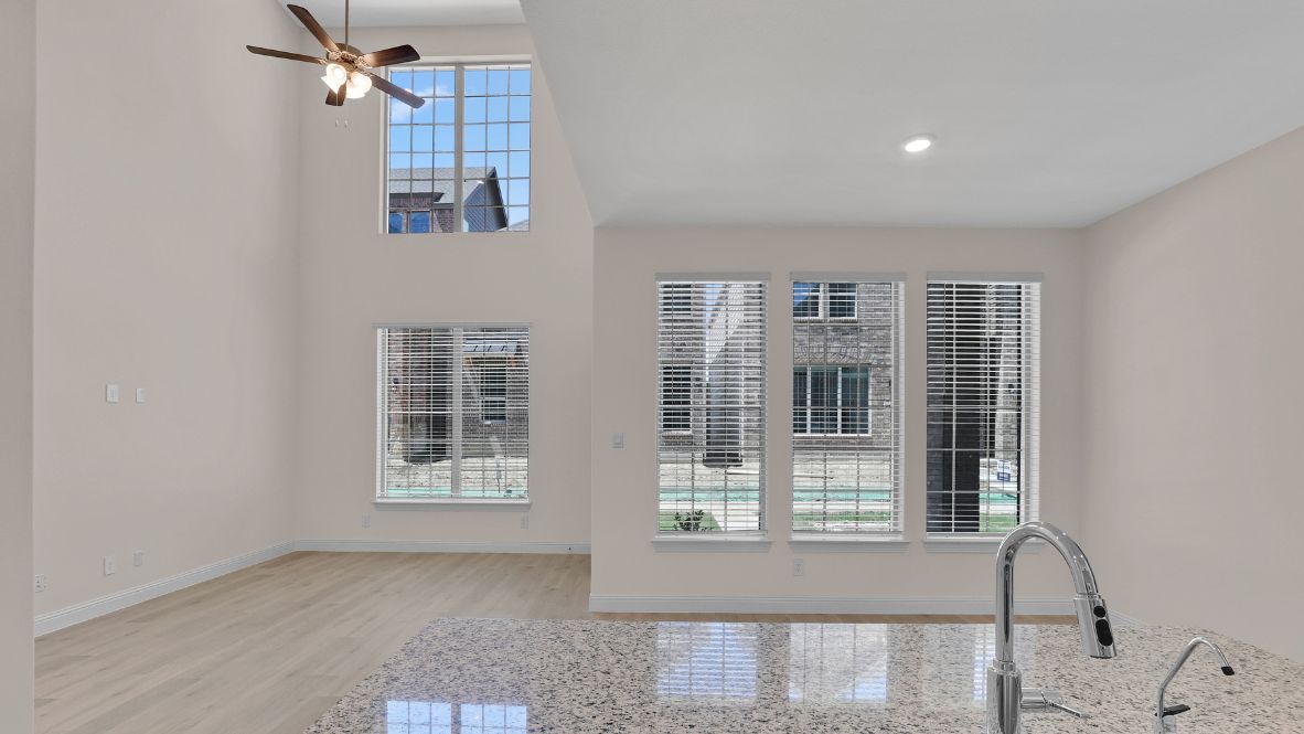 Open-concept dining area facing windows providing plenty of natural light.