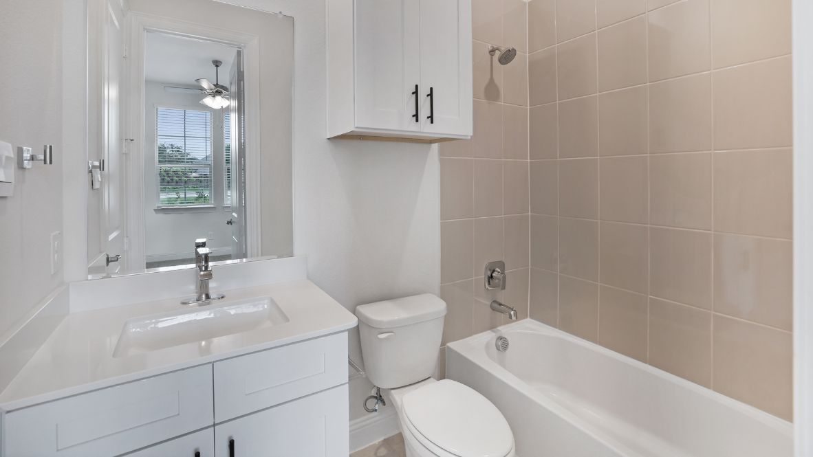 bathroom with a vanity sink, toilet and shower