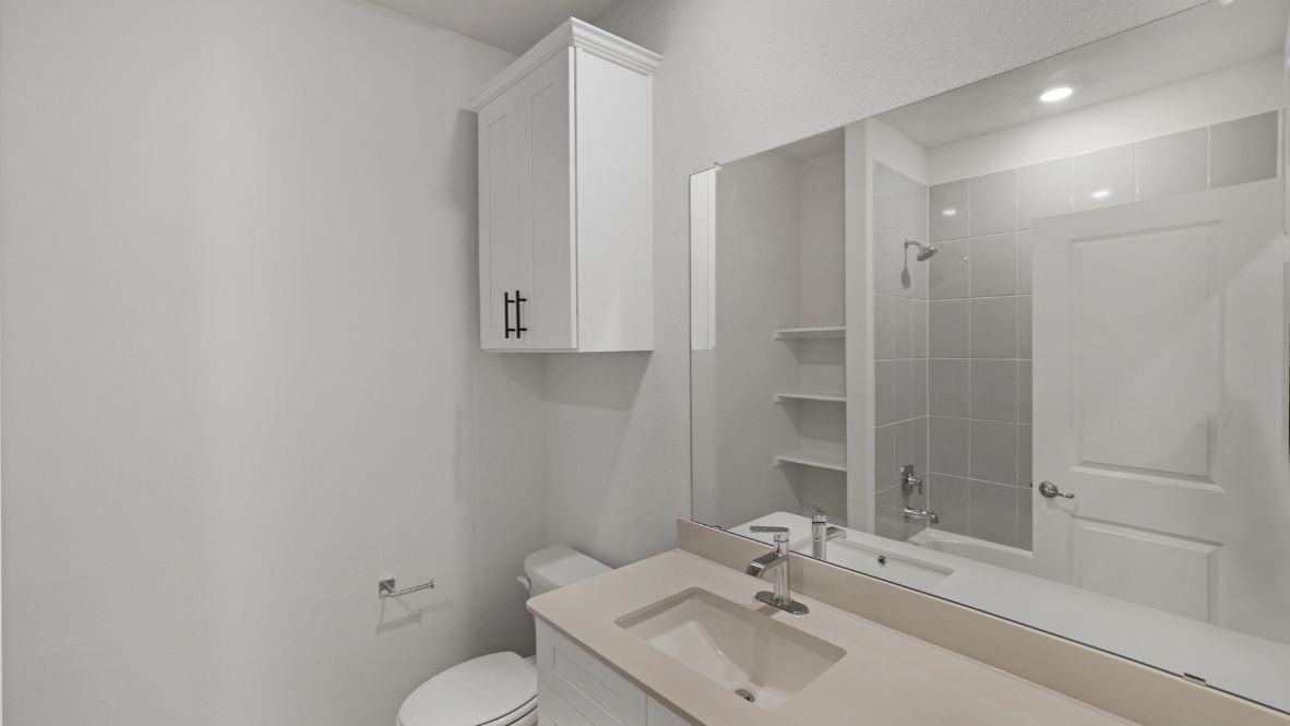 bathroom with a vanity sink, toilet and shower