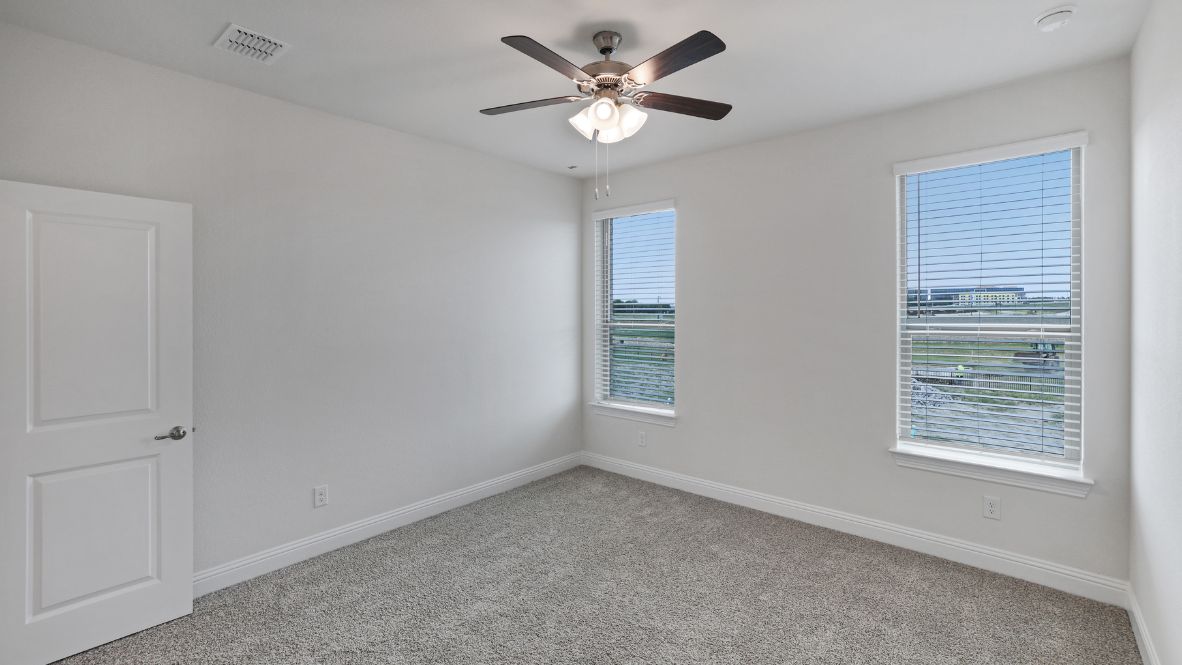 bedroom with grey carpet and white walls and a window