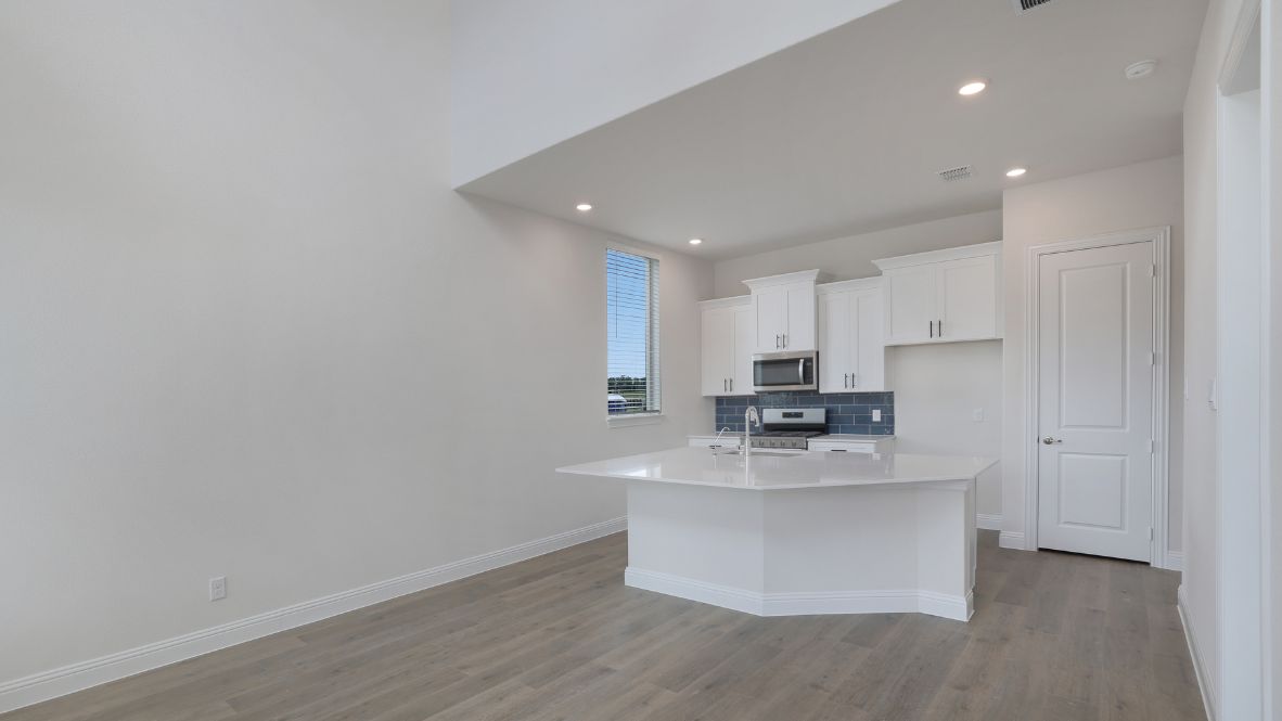 kitchen with white cabinetry, large island, and stainless steel appliances