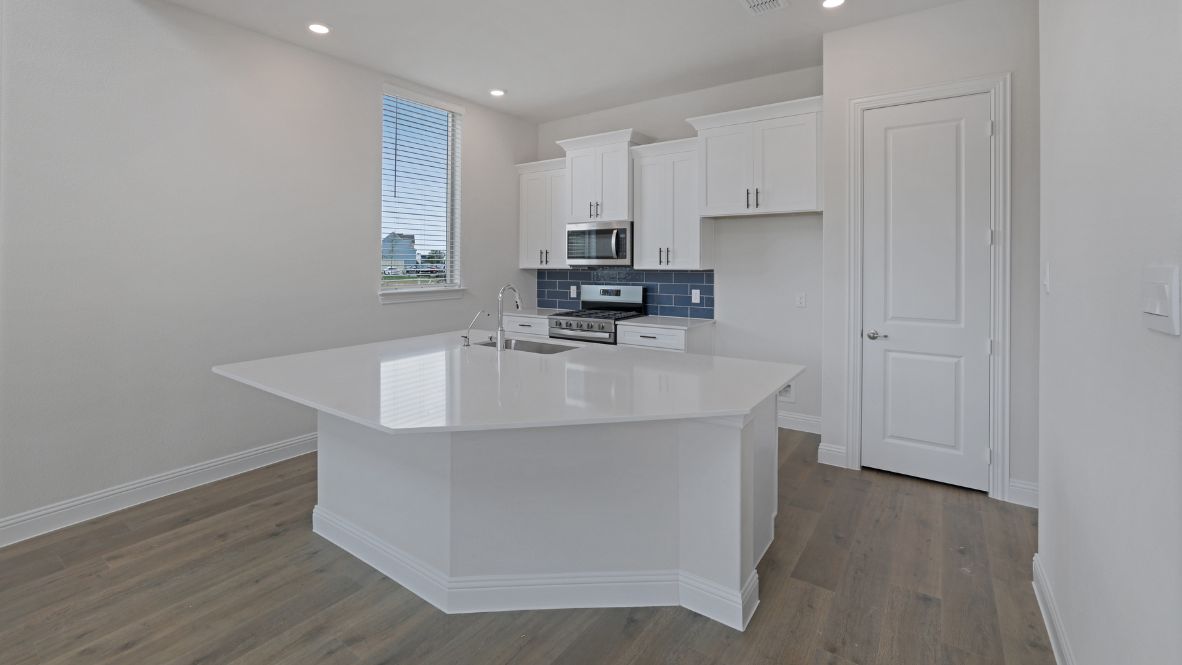 kitchen with white cabinetry, large island, and stainless steel appliances