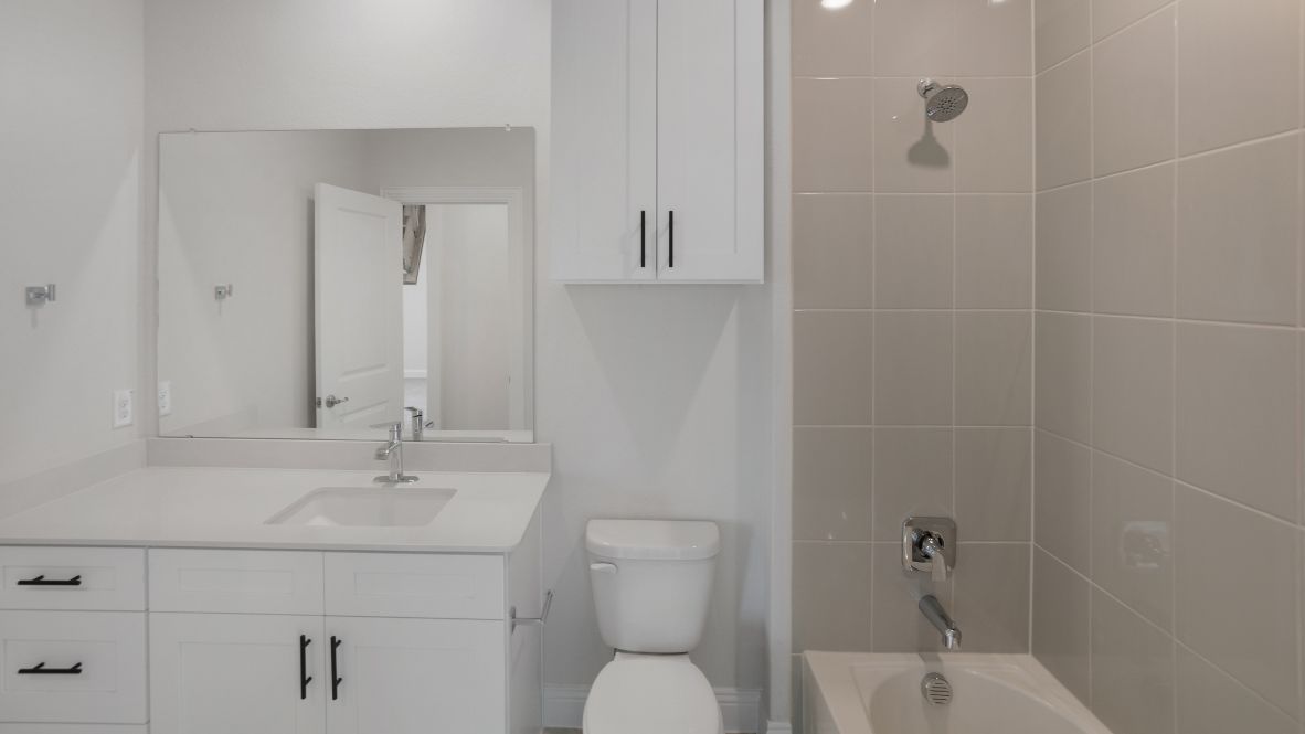 bathroom with a vanity sink, toilet and shower
