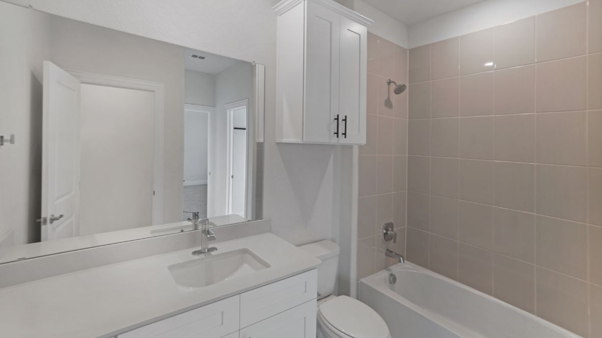 bathroom with a vanity sink, toilet and shower