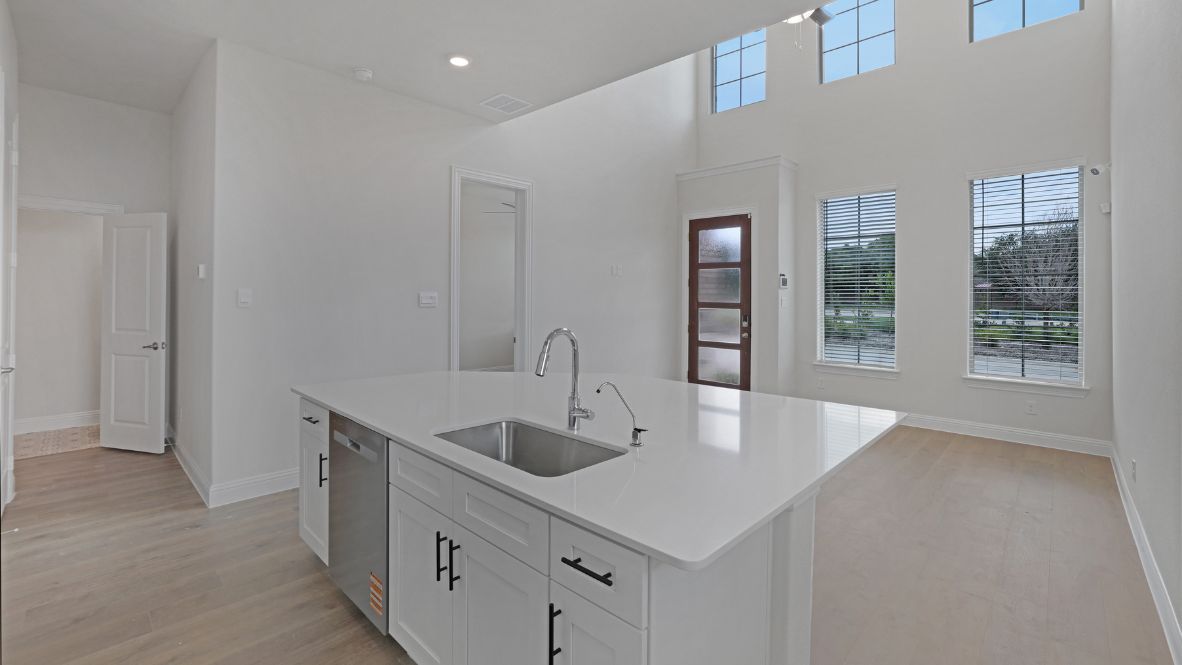 kitchen with white cabinetry, large island, and stainless steel appliances