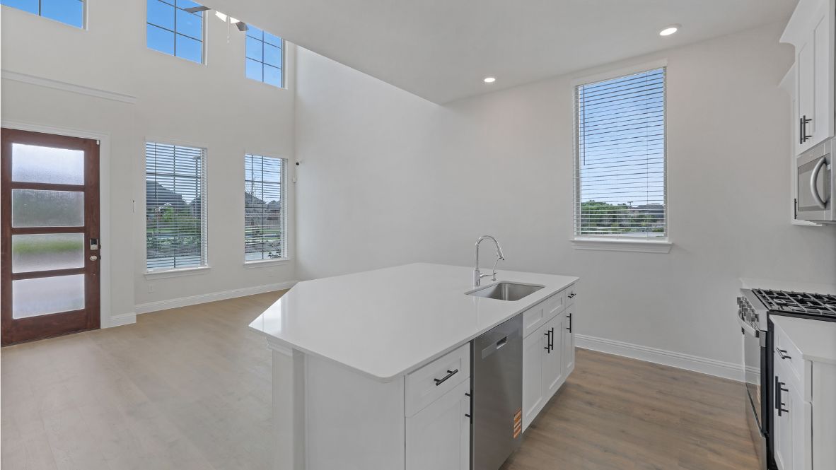 kitchen with white cabinetry, large island, and stainless steel appliances