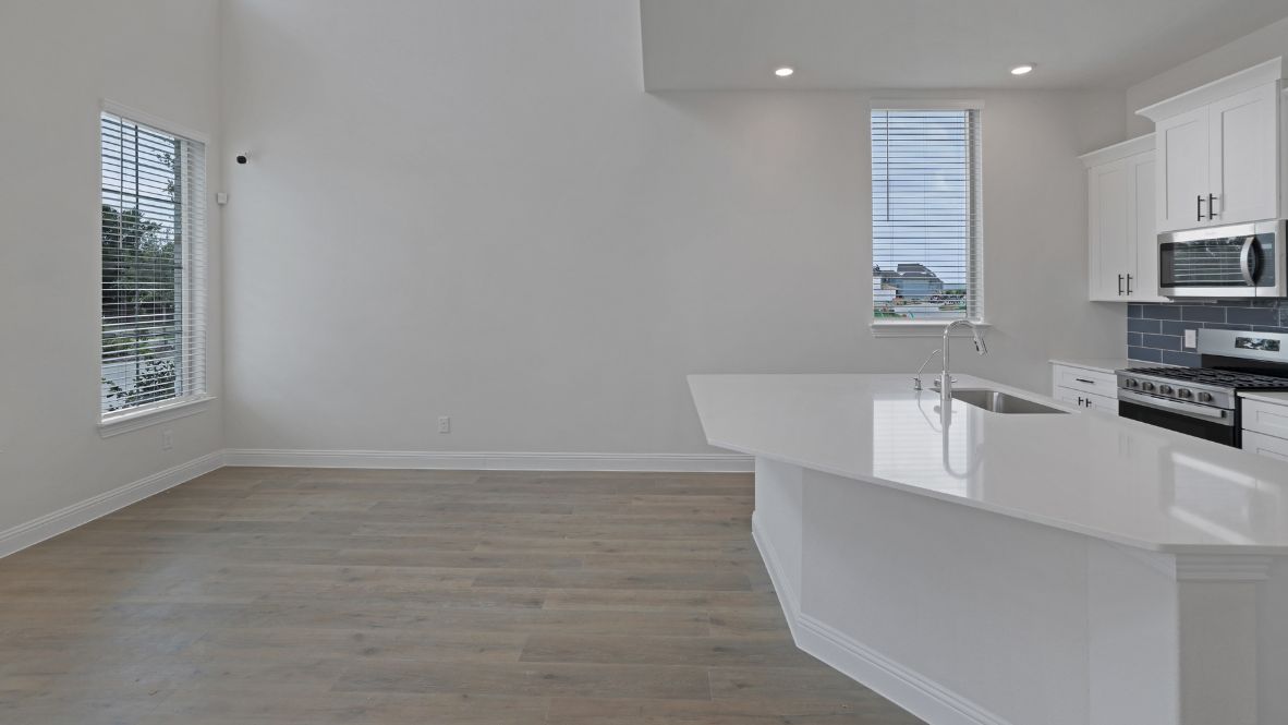 kitchen with white cabinetry, large island, and stainless steel appliances