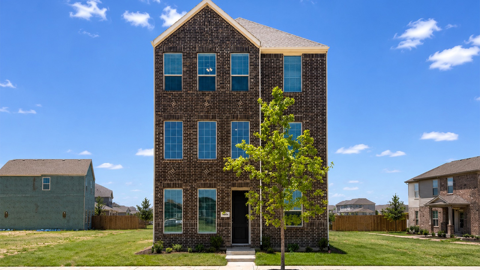 modern three-story brick house in allen, texas.