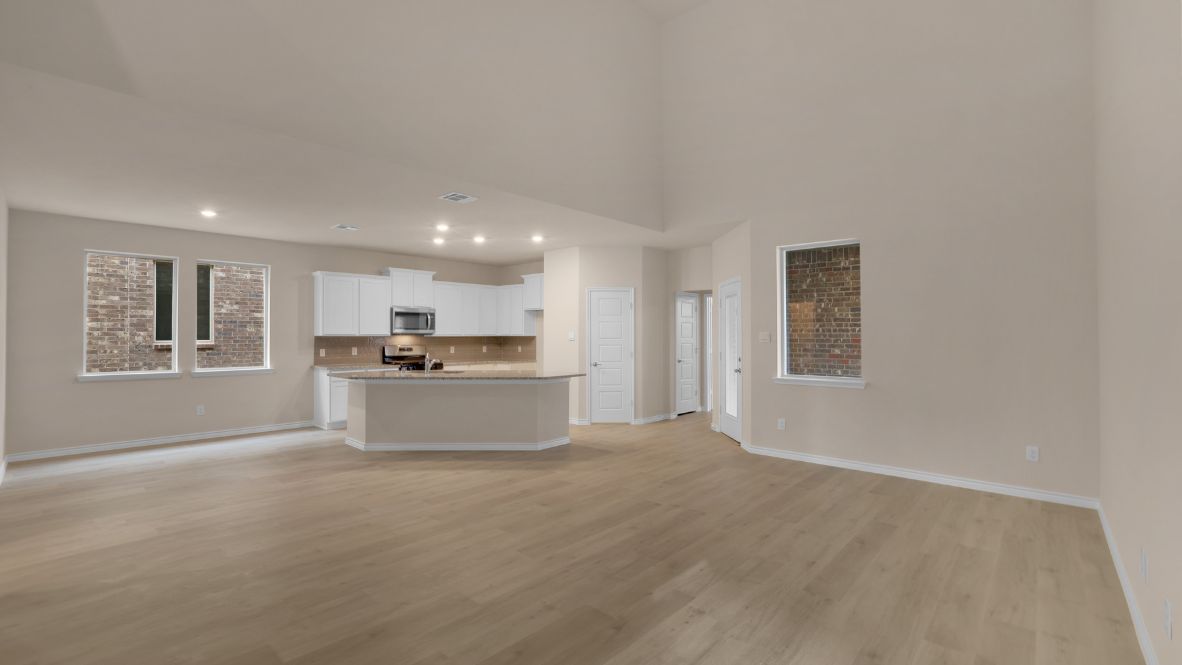 The home transitions into an open-concept layout featuring the corner kitchen layout, nook, and family room. The kitchen is a true centerpiece, equipped with a large center island, plenty of counter space, and modern appliances. With ample cabinetry and a convenient pantry, it’s designed to make both meal prep and storage a breeze. The nook sits adjacent to the kitchen, offering a cozy dining space for family meals or casual gatherings. To your left is the powder room, perfectly placed for guests. Tucked away off the nook is a powder room, perfectly placed for guests.