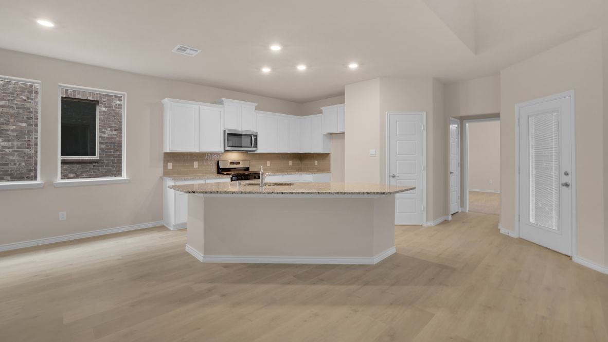 The home transitions into an open-concept layout featuring the corner kitchen layout, nook, and family room. The kitchen is a true centerpiece, equipped with a large center island, plenty of counter space, and modern appliances. With ample cabinetry and a convenient pantry, it’s designed to make both meal prep and storage a breeze. The nook sits adjacent to the kitchen, offering a cozy dining space for family meals or casual gatherings. To your left is the powder room, perfectly placed for guests. Tucked away off the nook is a powder room, perfectly placed for guests.