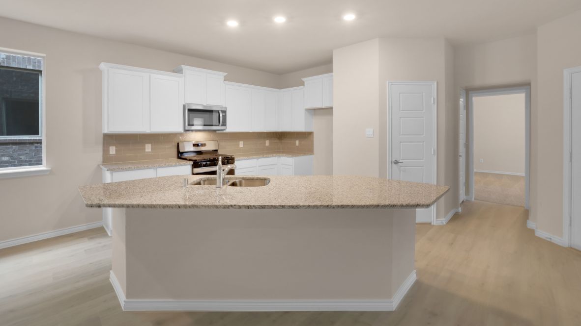 The home transitions into an open-concept layout featuring the corner kitchen layout, nook, and family room. The kitchen is a true centerpiece, equipped with a large center island, plenty of counter space, and modern appliances. With ample cabinetry and a convenient pantry, it’s designed to make both meal prep and storage a breeze. The nook sits adjacent to the kitchen, offering a cozy dining space for family meals or casual gatherings. To your left is the powder room, perfectly placed for guests. Tucked away off the nook is a powder room, perfectly placed for guests.