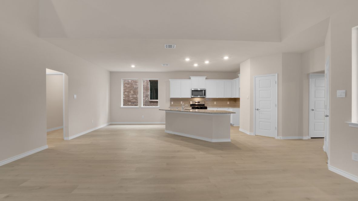 The home transitions into an open-concept layout featuring the corner kitchen layout, nook, and family room. The kitchen is a true centerpiece, equipped with a large center island, plenty of counter space, and modern appliances. With ample cabinetry and a convenient pantry, it’s designed to make both meal prep and storage a breeze. The nook sits adjacent to the kitchen, offering a cozy dining space for family meals or casual gatherings. To your left is the powder room, perfectly placed for guests. Tucked away off the nook is a powder room, perfectly placed for guests.